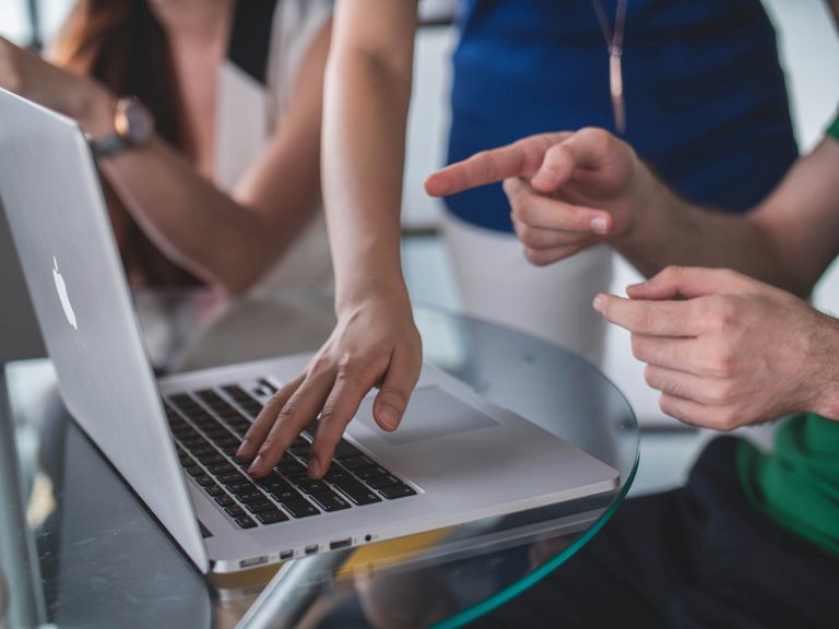 two people in front of a laptop