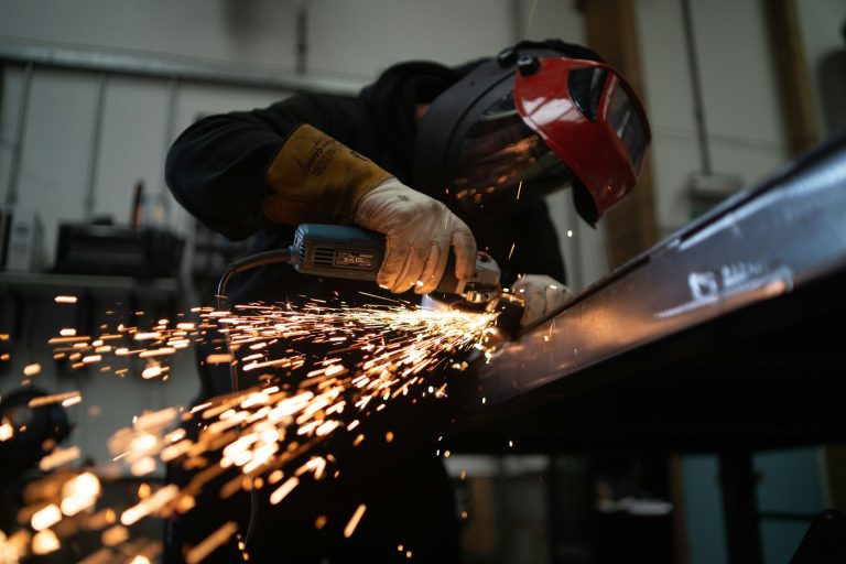 man welding metals